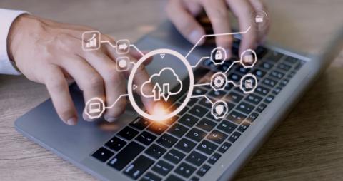 Man using laptop with cloud computing diagram overlay. Internet service concept.